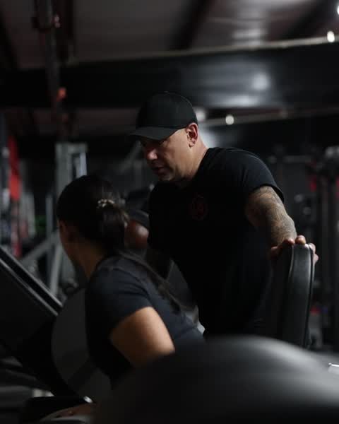 Chris coaching a client on a machine
